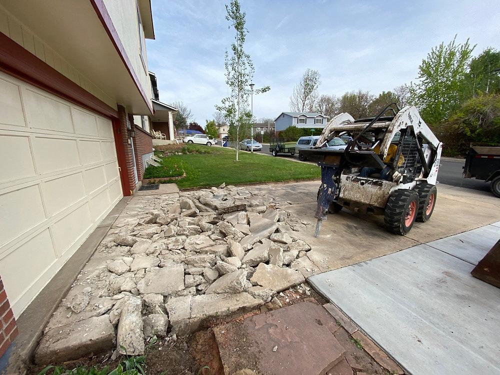 Old cracked and damaged concrete driveway ready for removal and replacement.