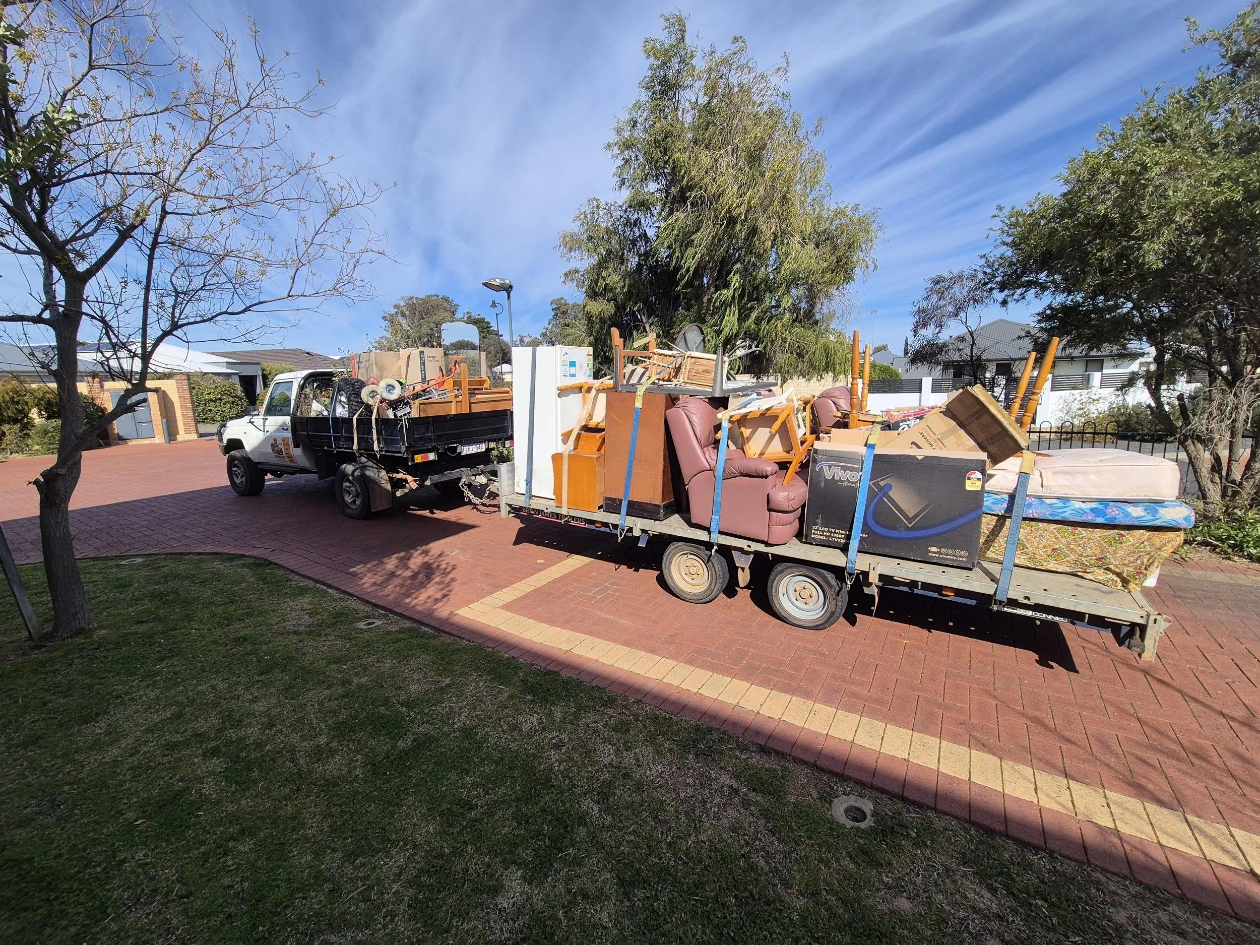 Professional rubbish removal truck collecting unwanted household items