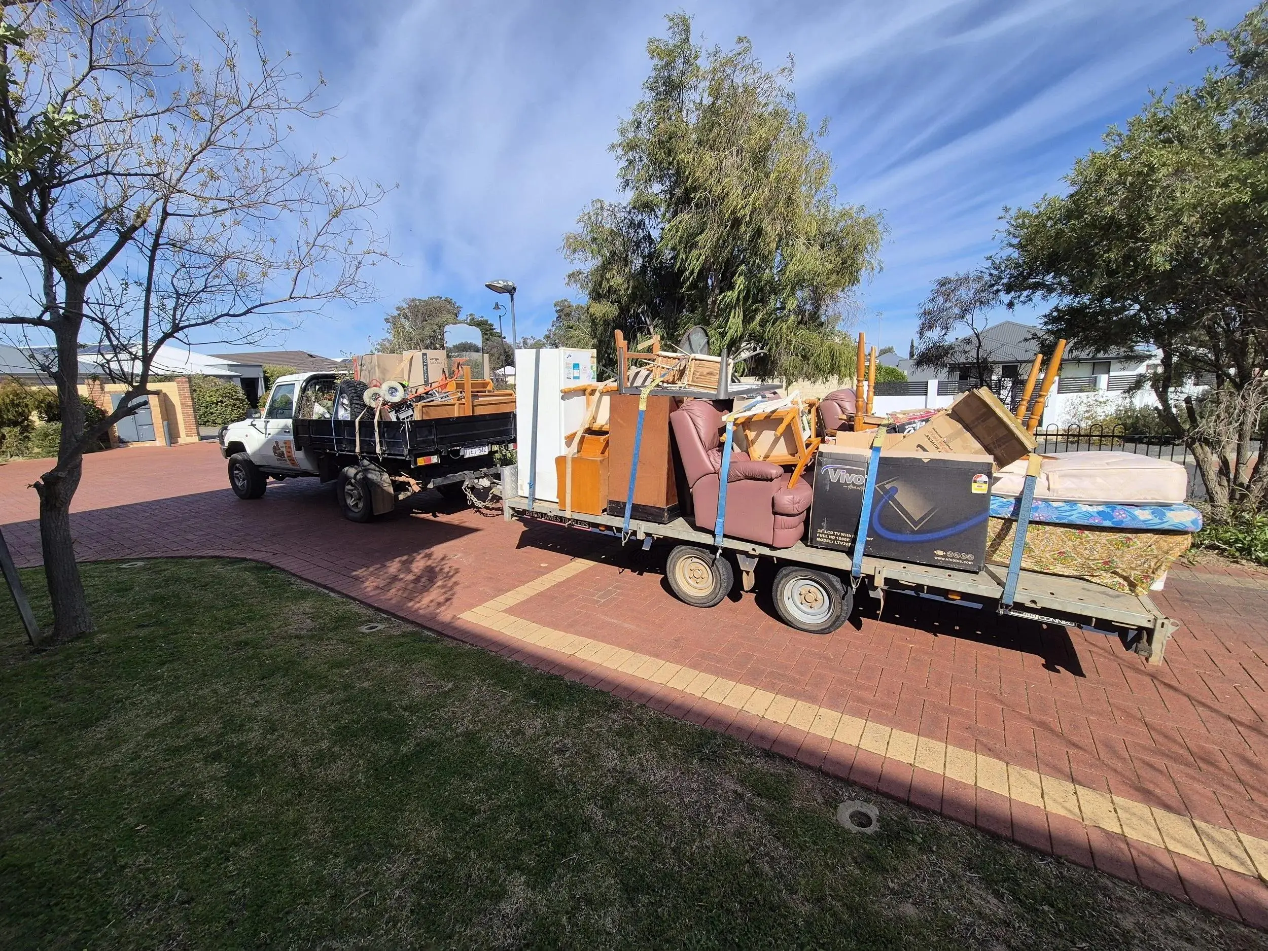 Professional rubbish removal truck collecting unwanted household items